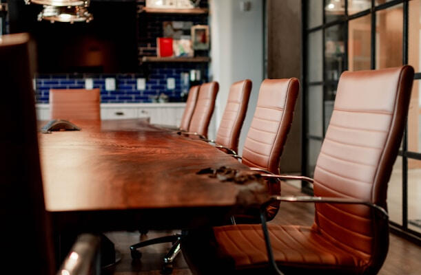 The WhiteCliff Group A conference room with wooden table and leather executive chairs